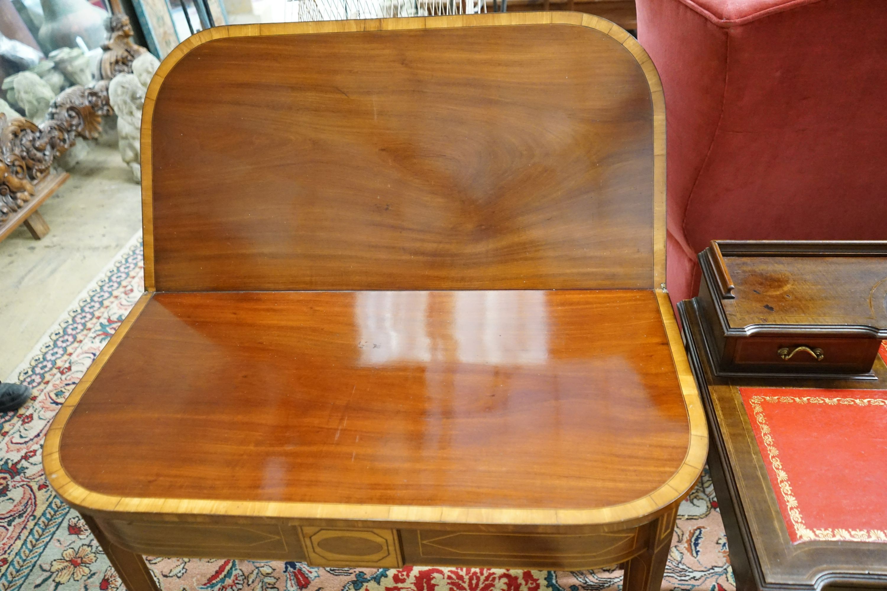 A George III satinwood banded mahogany D shaped folding tea table, width 94cm, depth 48cm, height 75cm